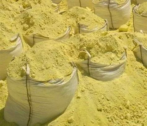 Crushed sulfur loaded into large industrial bags